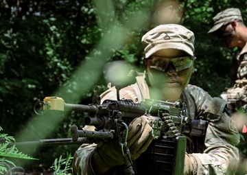 U.S. Army Pfc. conducts security operations with an M240 machine gun during a squad-level maneuver lane at Camp Casey, South Korea, July 29 2025
