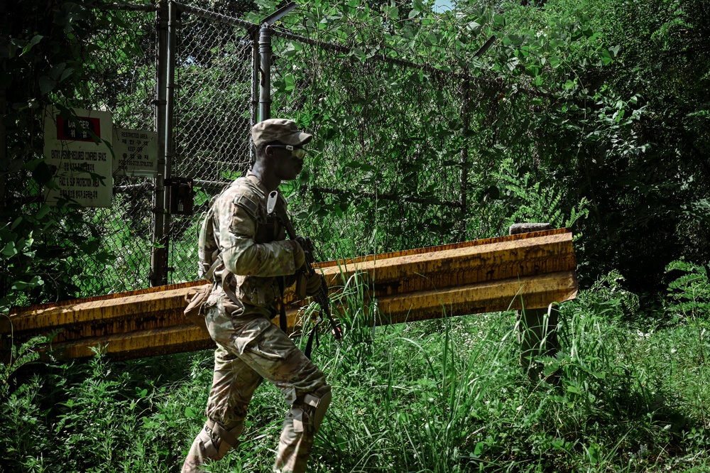 A rifleman from B Co., 4-9IN continues movement across a mountain ridge line during situational training at Camp Casey, South Korea, July 29, 2025