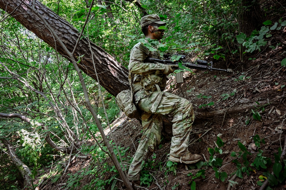 A rifleman from B Co., 4-9IN maneuvers up a steep slope at Camp Casey Training Area, South Korea July 29, 2025