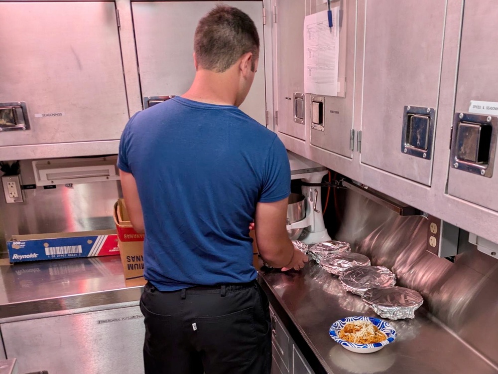USCGC Myrtle Hazard (WPC 1139) delivers dinner to Station Apra Harbor crews underway