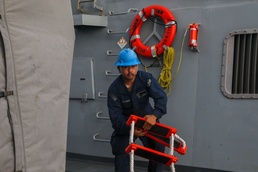 Sailors aboard the USS John Finn conduct a sea and anchor detail in Diego Garcia