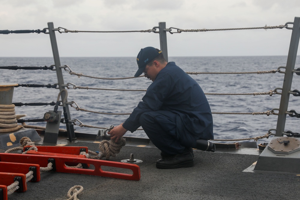 Sailors aboard the USS John Finn conduct a sea and anchor detail in Diego Garcia