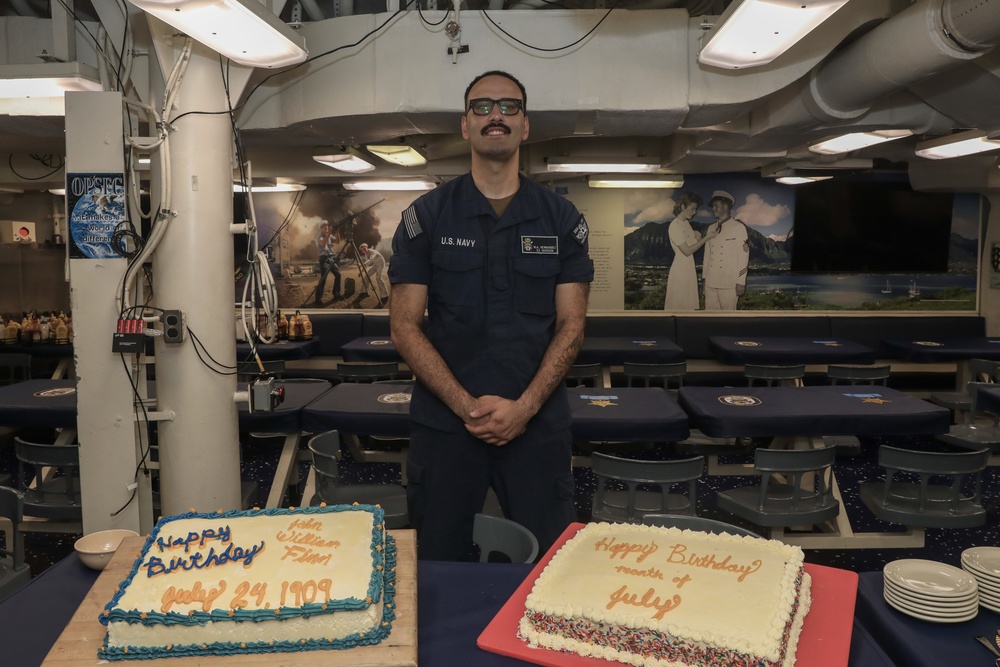 Sailors aboard the USS John Finn hold a birthday celebration on the messdecks in Diego Garcia