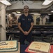 Sailors aboard the USS John Finn hold a birthday celebration on the messdecks in Diego Garcia
