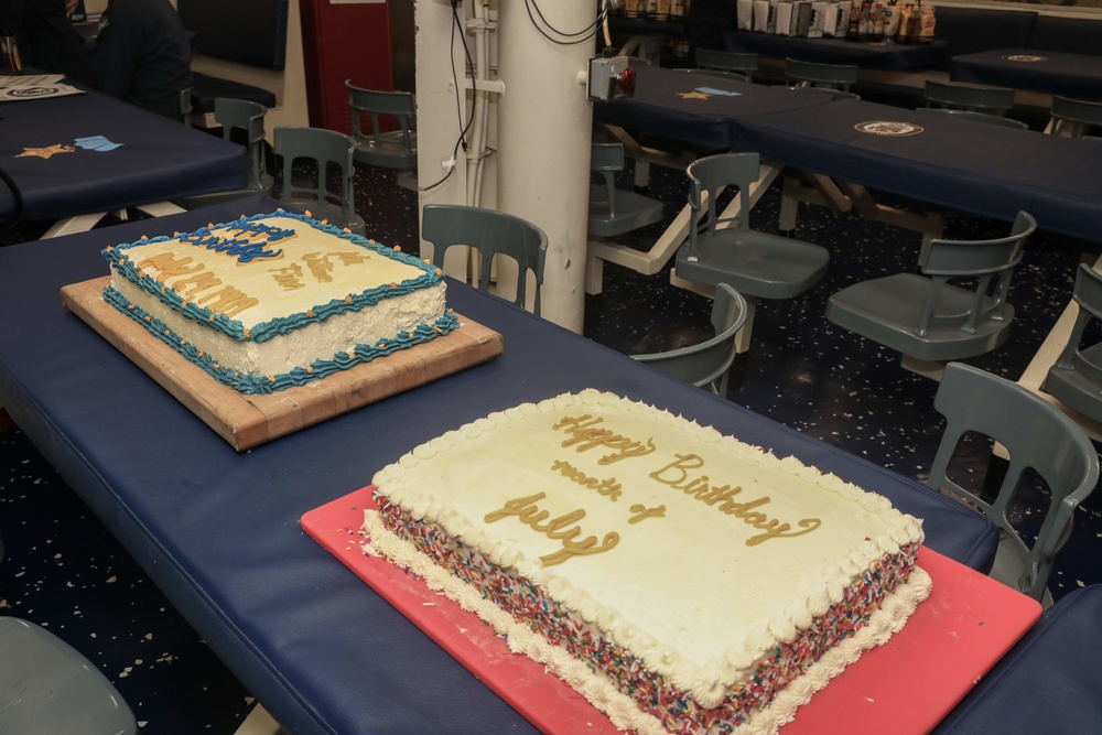 Sailors aboard the USS John Finn hold a birthday celebration on the messdecks in Diego Garcia