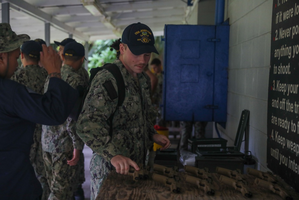 Sailors assigned to the USS John Finn conduct a small arms gun shoot in Diego Garcia