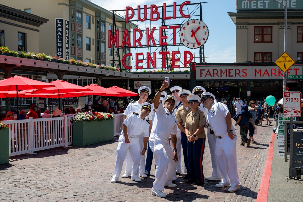 Sailors and Marines tour Pike Place Market during Seattle Fleet Week 2025