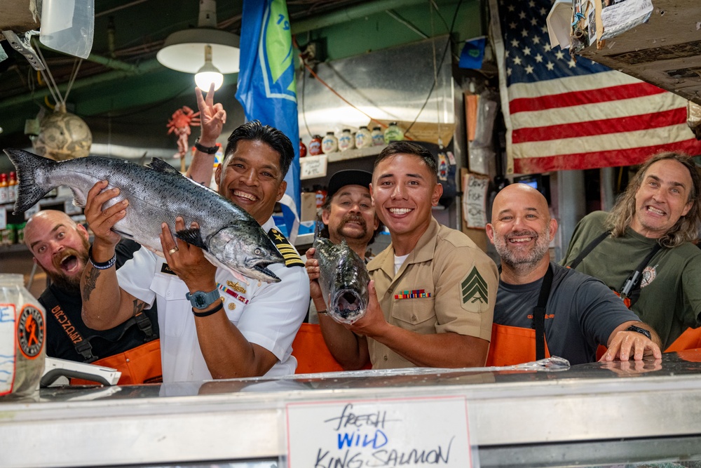 Sailors and Marines tour Pike Place Market during Seattle Fleet Week 2025