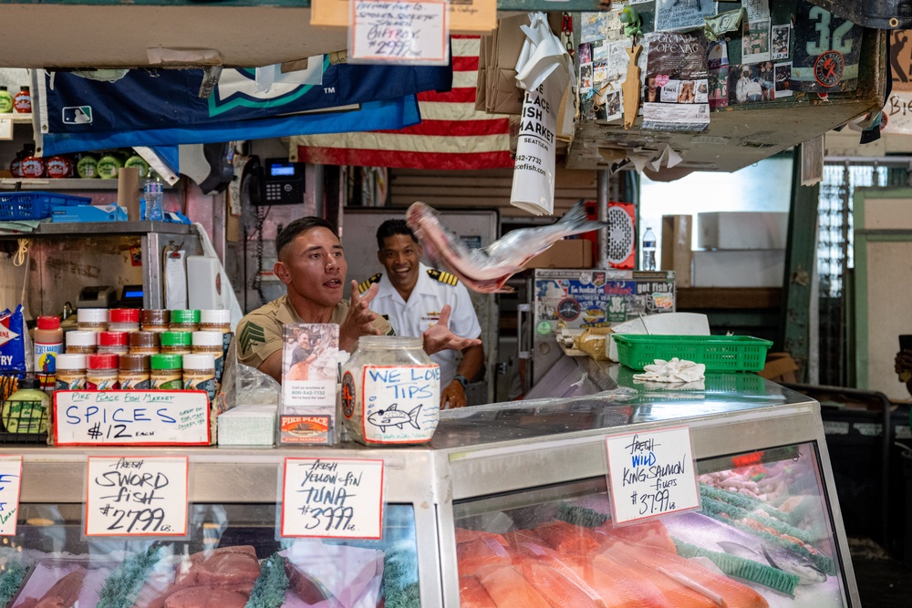 Sailors and Marines tour Pike Place Market during Seattle Fleet Week 2025