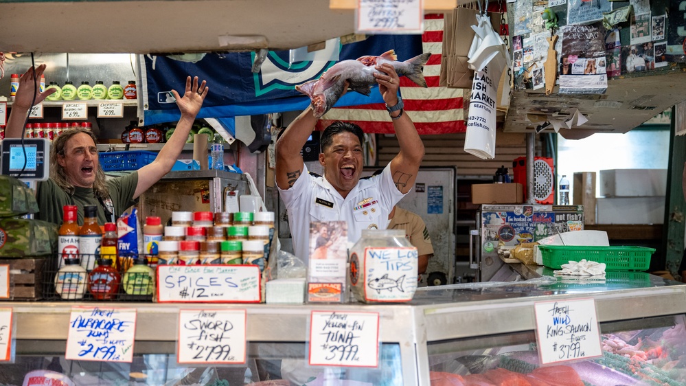 Sailors and Marines tour Pike Place Market during Seattle Fleet Week 2025