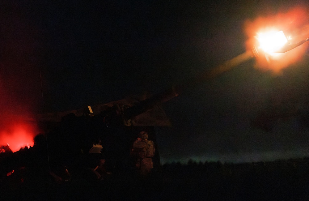 Gun Devils fire artillery at night during Devil Avalanche