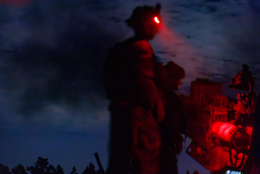 Gun Devils fire artillery at night during Devil Avalanche