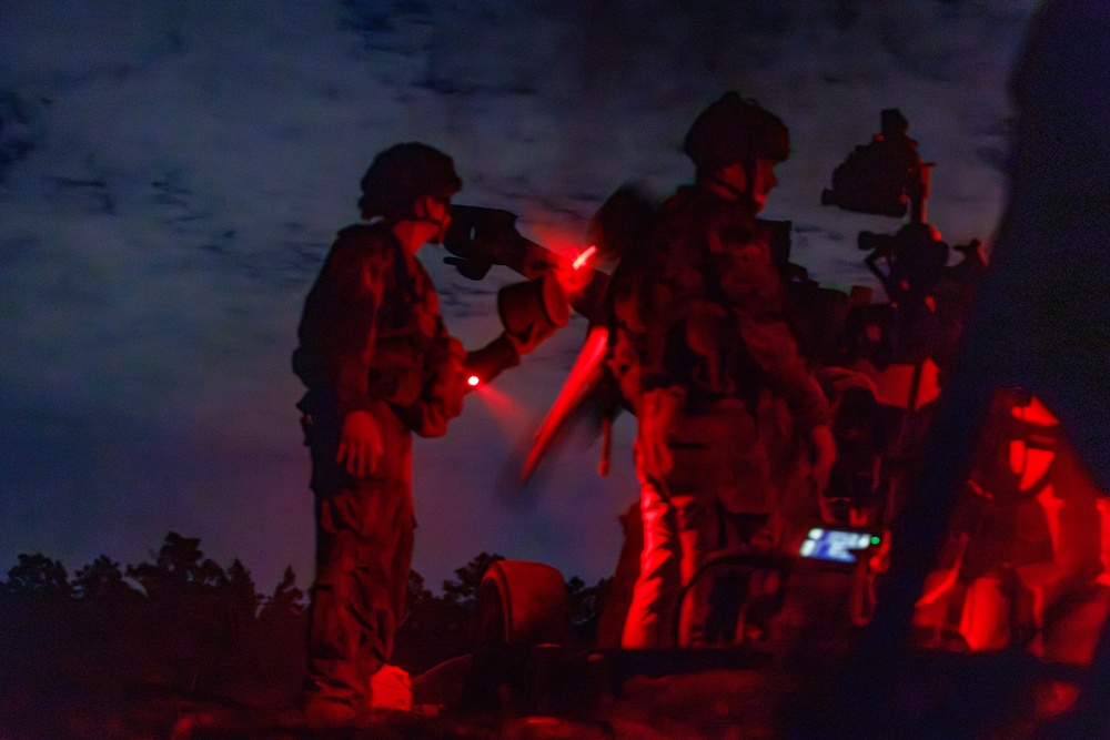 Gun Devils fire artillery at night during Devil Avalanche