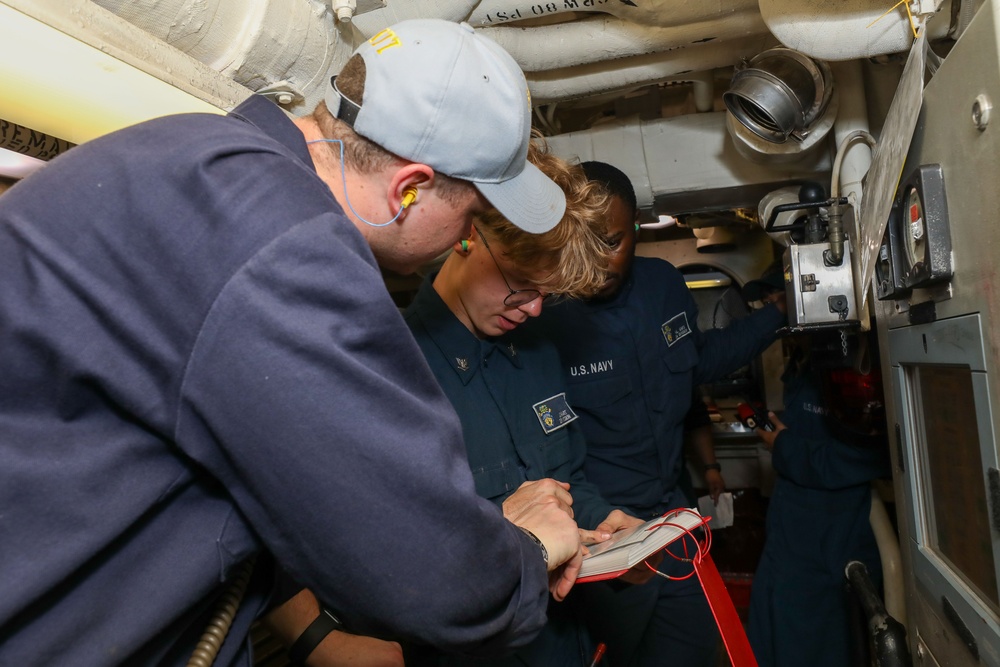 Sailors aboard the USS John Finn conduct an engineering training team drill in the Indian Ocean