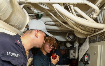 Sailors aboard the USS John Finn conduct an engineering training team drill in the Indian Ocean