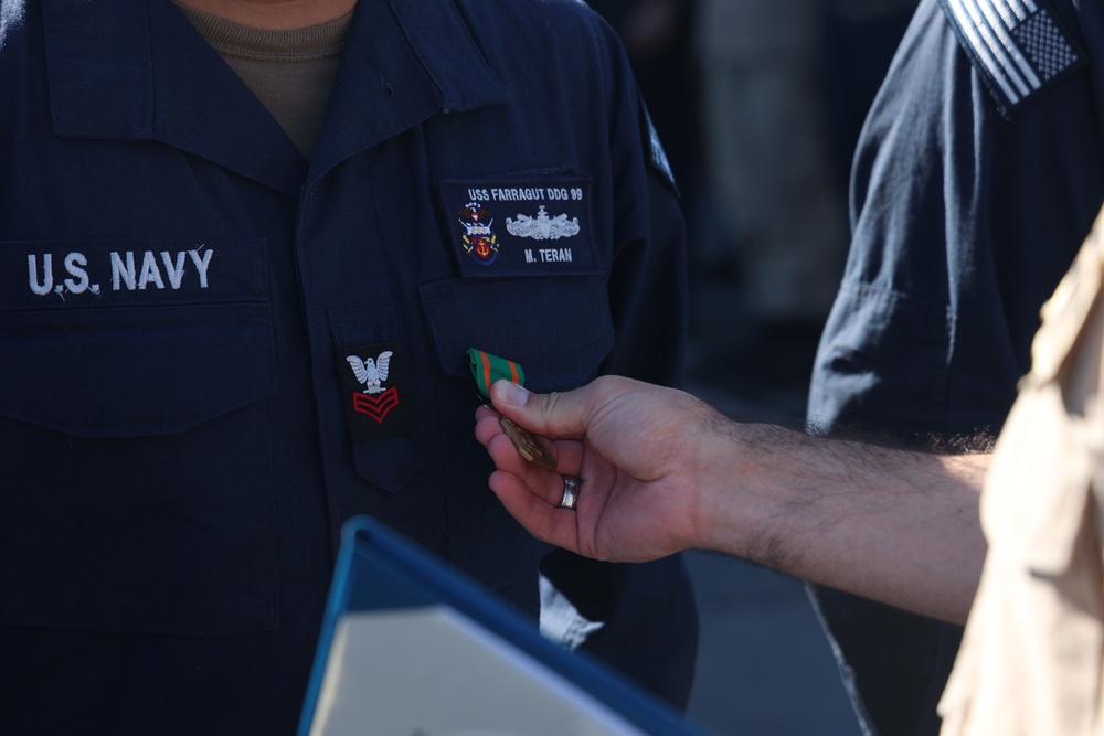 QM1 Teran Receives the Navy and Marine Corps Achievement Medal From CDR Timper, Commanding Officer of USS FARRAGUT