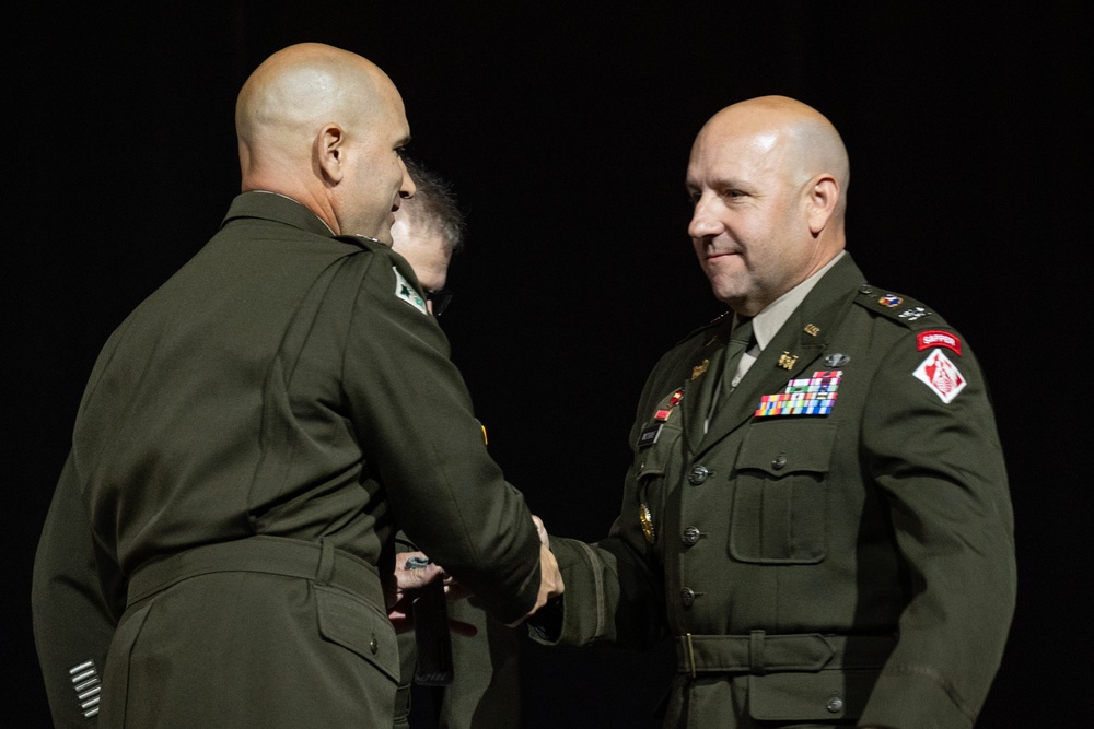 Commanders shake hands during transition ceremony