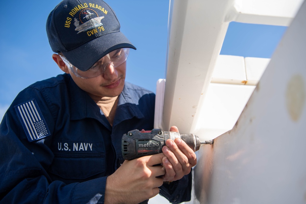 Reagan Sailors perform maintenance