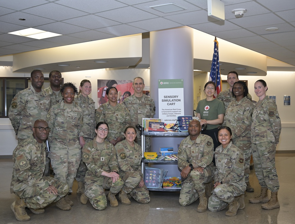 Leadership and staff from the 60th Medical Group join representatives from the American Red Cross to unveil the new Sensory Simulation Cart