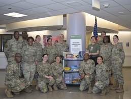 Leadership and staff from the 60th Medical Group join representatives from the American Red Cross to unveil the new Sensory Simulation Cart