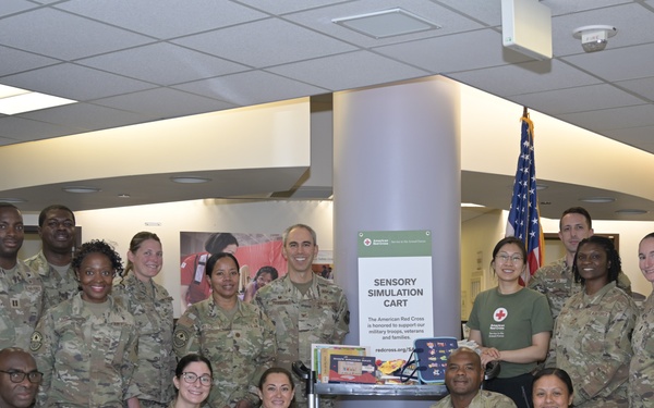 Leadership and staff from the 60th Medical Group join representatives from the American Red Cross to unveil the new Sensory Simulation Cart