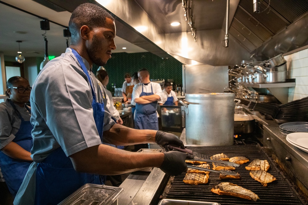 Navy and Coast Guard culinary specialists take a cooking lesson during Seattle Fleet Week 2025