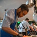 Navy and Coast Guard culinary specialists take a cooking lesson during Seattle Fleet Week 2025