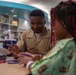 wo Sailors and a Marine visit the Seattle Children’s Hospital