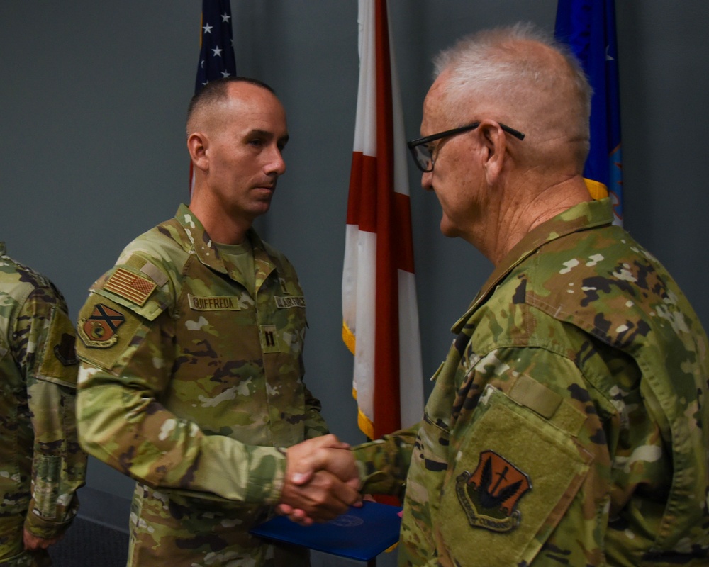 Chaplain Guiffreda is presented with the Air and Space Achievement Medal