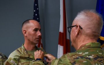 Chaplain Guiffreda is presented with the Air and Space Achievement Medal