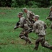 Soldiers with 2nd Battalion, 23rd Infantry Regiment assault through a target area during a squad live-fire exercise at the Story Live Fire Complex, South Korea, July 31, 2025.