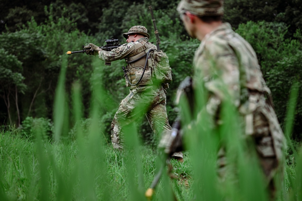 U.S. Soldiers assigned to 2nd Battalion, 23rd Infantry Regiment react to contact during a squad live-fire iteration at the Story Live Fire Complex, South Korea, July 31, 2025.