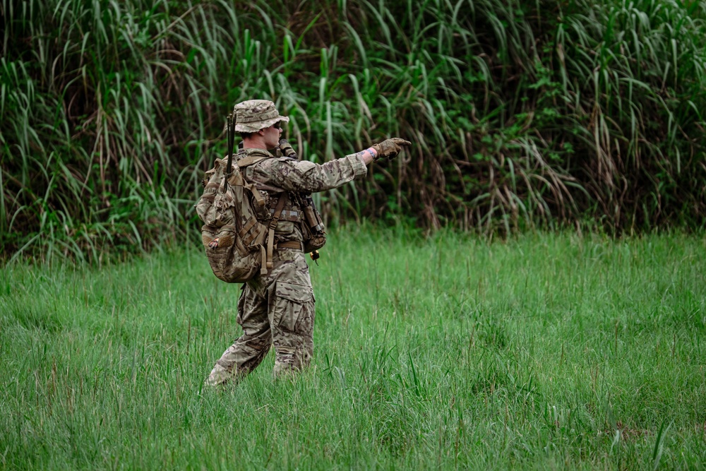 A team leader from 2nd Battalion, 23rd Infantry Regiment signals to his team during movement across open terrain at the Story Live Fire Complex, South Korea, July 31, 2025.