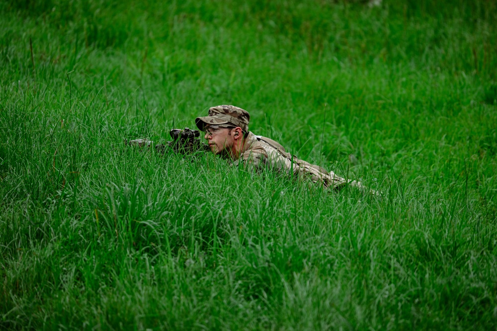 A Soldier with 2nd Battalion, 23rd Infantry Regiment establishes a support-by-fire position during a squad live-fire exercise at the Story Live Fire Complex, South Korea, July 31, 2025.