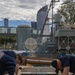 USS Frank Cable (AS 40) and USS Ohio (SSGN 726) Sailors participate in a COMREL at Queensland Maritime Museum