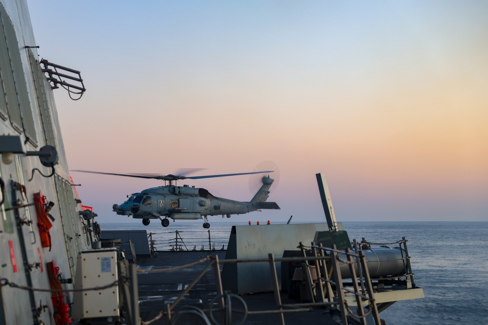 An MH-60R Sea Hawk helicopter lifts off from the USS Bulkeley flight deck