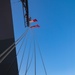 QMSA Jace Orourke hoists the ensign aboard USS Bulkeley