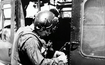 Upscale image of Seawolf HA(L)-3 Gunship U.S. Navy crewman reloads M60 machine gun of a HA(L)-3 UH-1B aboard USS Harnett County (LST821), Vietnam, 10 September 1969 (K-58290)
