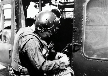 Upscale image of Seawolf HA(L)-3 Gunship U.S. Navy crewman reloads M60 machine gun of a HA(L)-3 UH-1B aboard USS Harnett County (LST821), Vietnam, 10 September 1969 (K-58290)