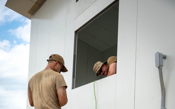Airmen Wire a Newly Built House