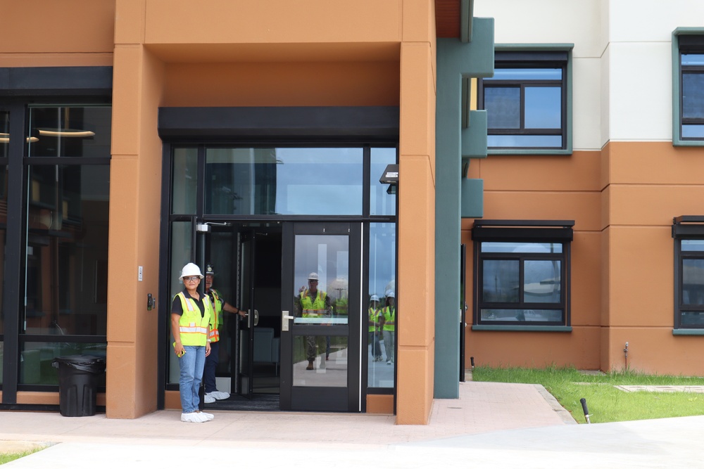 The Construction Manager for a New Bachelor Officer Quarters Greets Visitors