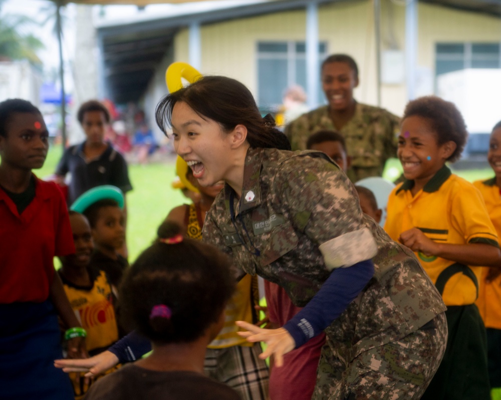 Pacific Partnership 2025 Multinational Servicemembers Play Games with local children in Lae, Papua New Guinea, August 2025