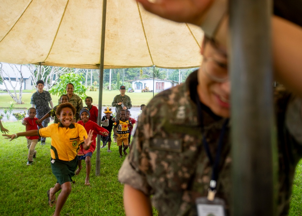 Pacific Partnership 2025 Multinational Service Members Play Games with local children in Lae, Papua New Guinea, August 2025