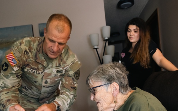 Command Sgt. Maj. Matthew Strasser presents coin to Iowa Army veteran