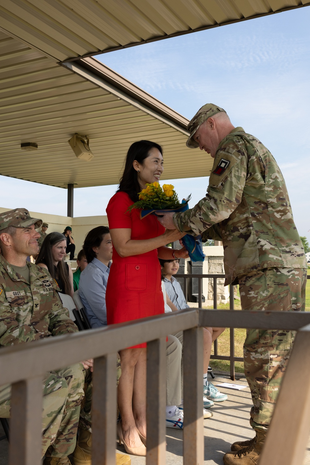 Soldier Hands Yellow Roses to Spouse