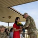 Soldier Hands Yellow Roses to Spouse