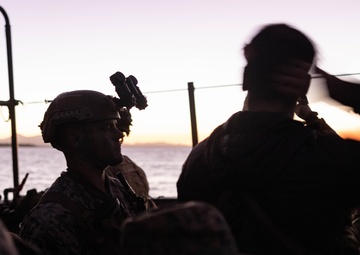 U.S. Marines with 1st Recon Bn., Australian Army soldiers prepare for nighttime small boat insertion