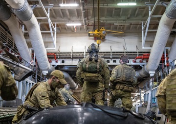 U.S. Marines with 1st Recon Bn., Australian Army soldiers prepare for nighttime small boat insertion