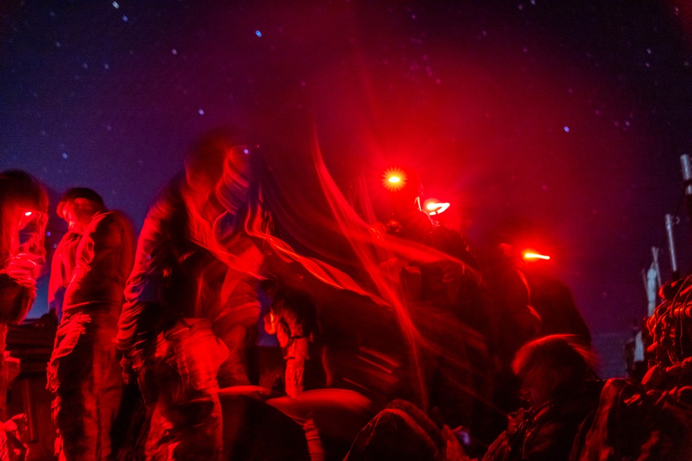 U.S. Marines with 1st Recon Bn., Australian Army soldiers prepare for nighttime small boat insertion