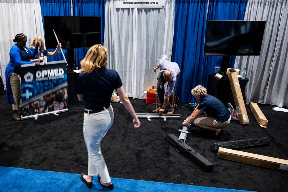 Operational Medical Systems team wraps exhibit during medical symposium day three